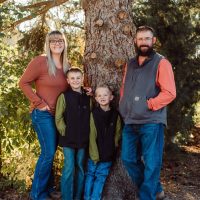 Family outdoor service dog training, high plains k-9 connections, community support for service dogs, family with service dogs in nature, outdoor service dog handler family, high plains K-9 Connections organization, helping people with service dogs through community programs.