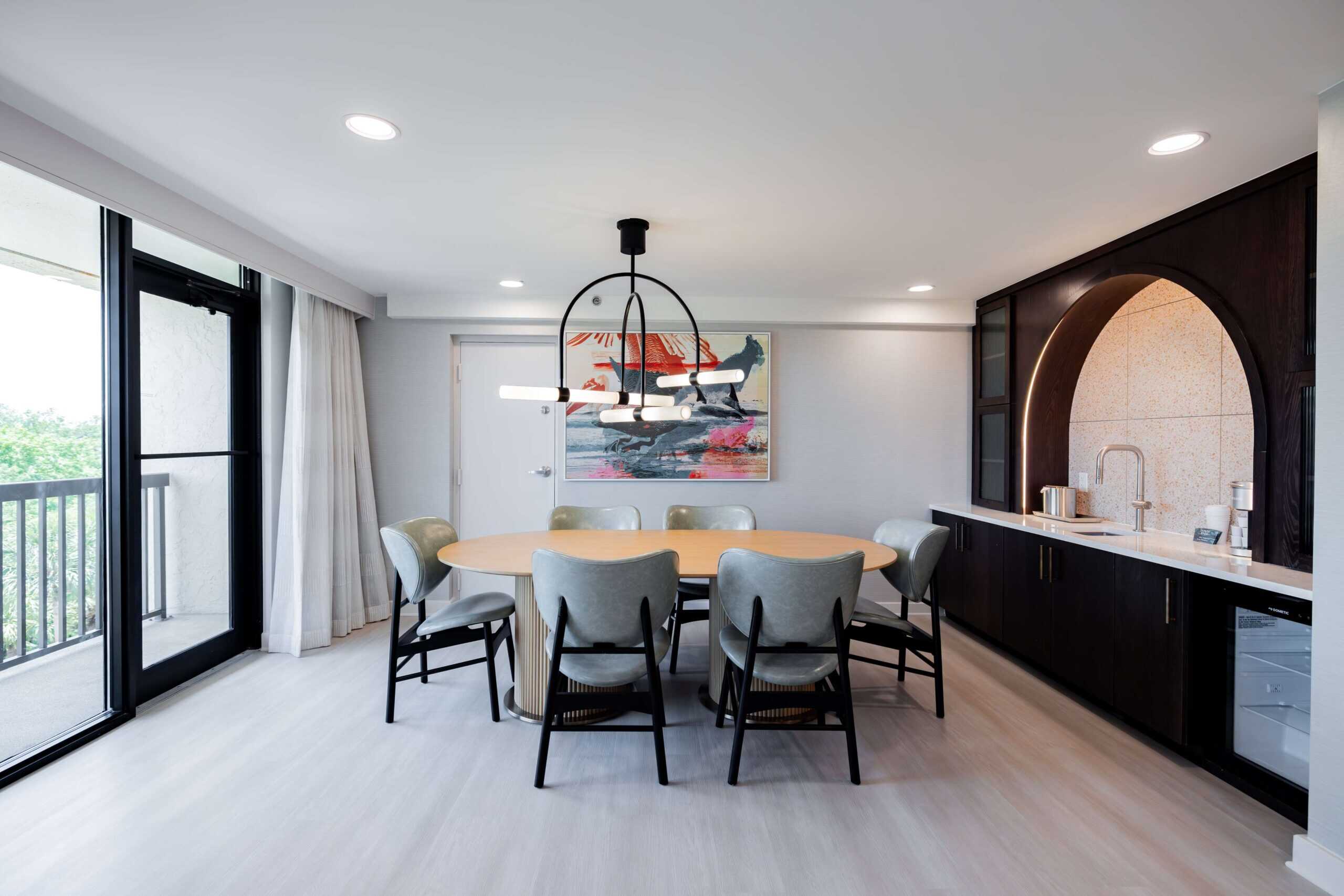 Dining area with chandelier and balcony access.