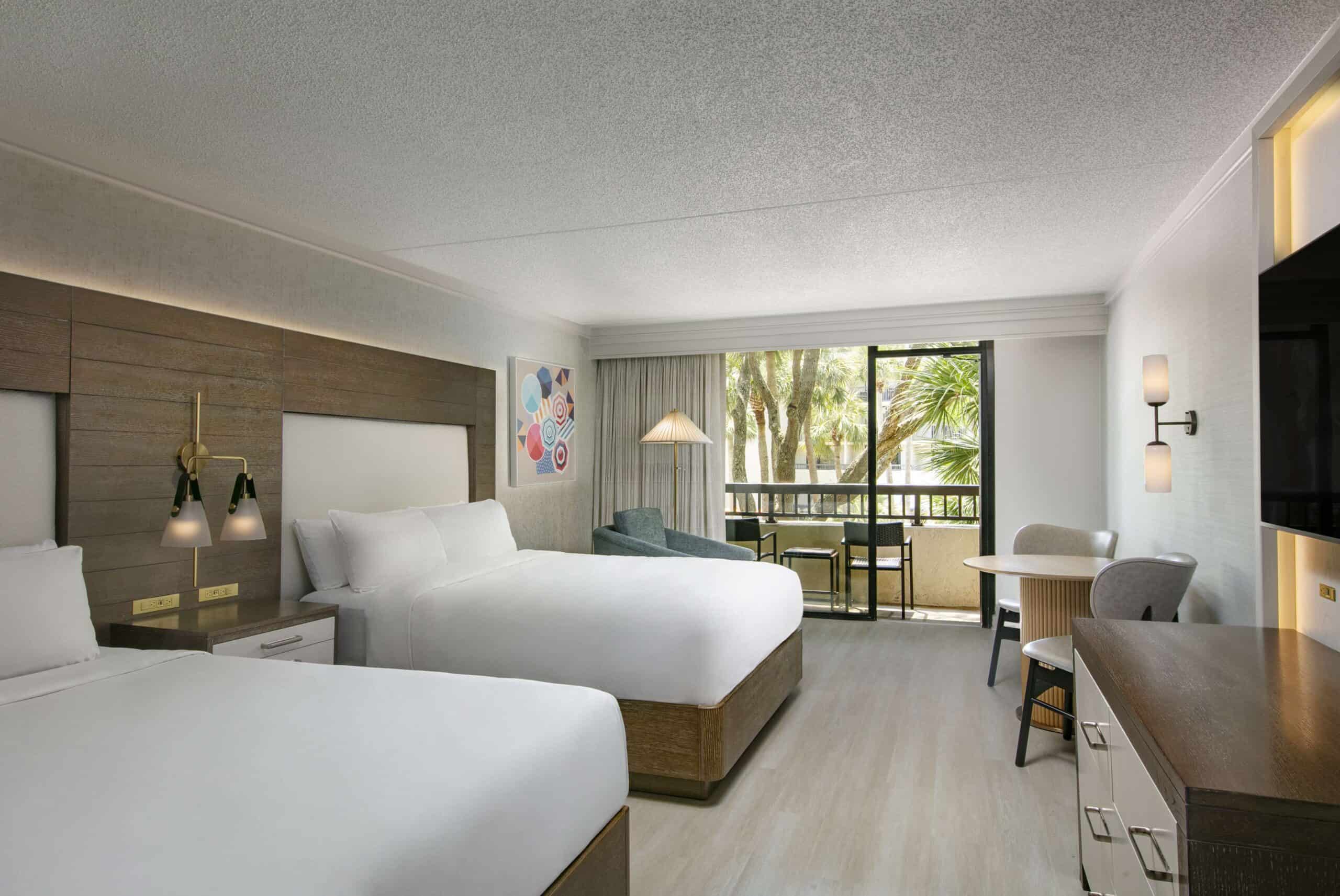 Double beds with natural light and balcony access.