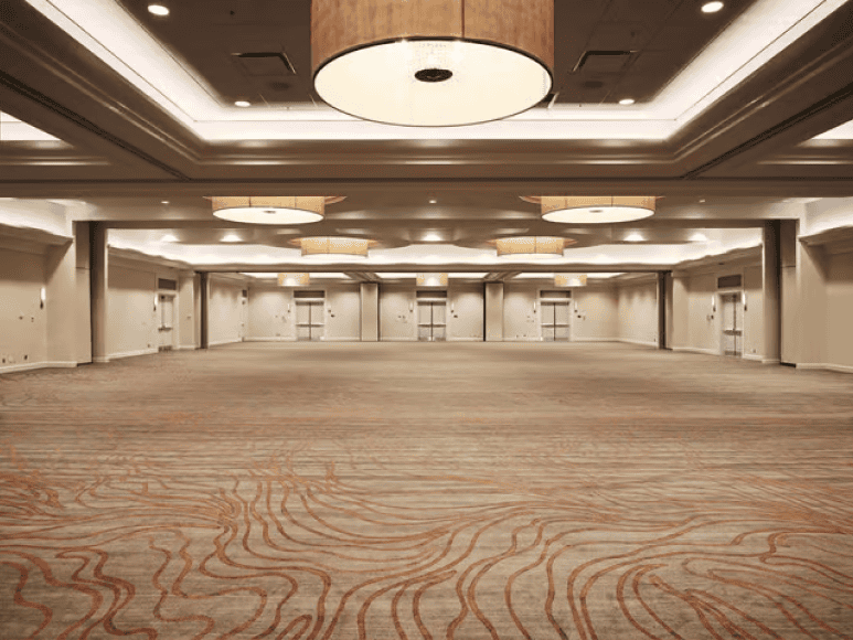 Spacious ballroom with modern lighting fixtures.