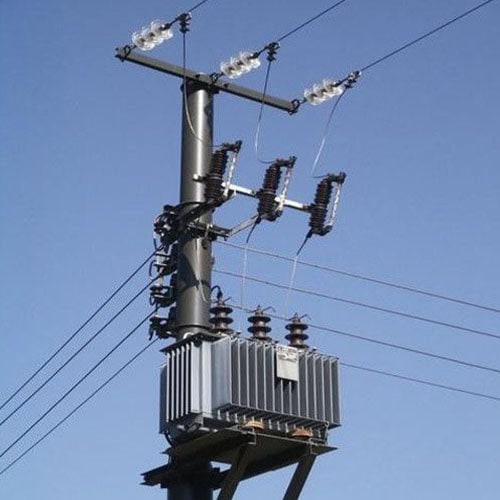 Power distribution transformer on utility pole with insulators and wires.