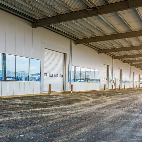 Industrial warehouse with large glass windows and multiple loading bays at Major Project Highlights.