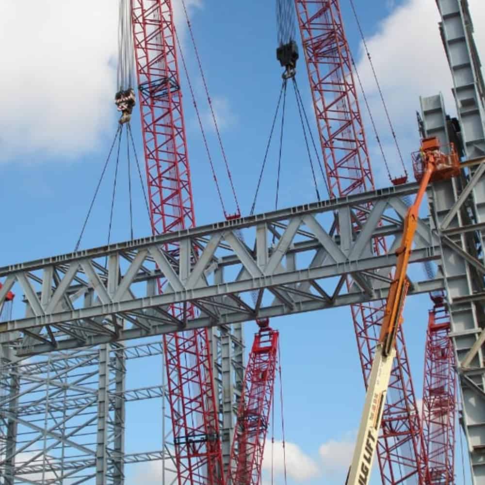 Construction crane lifting fabricated steel components.
