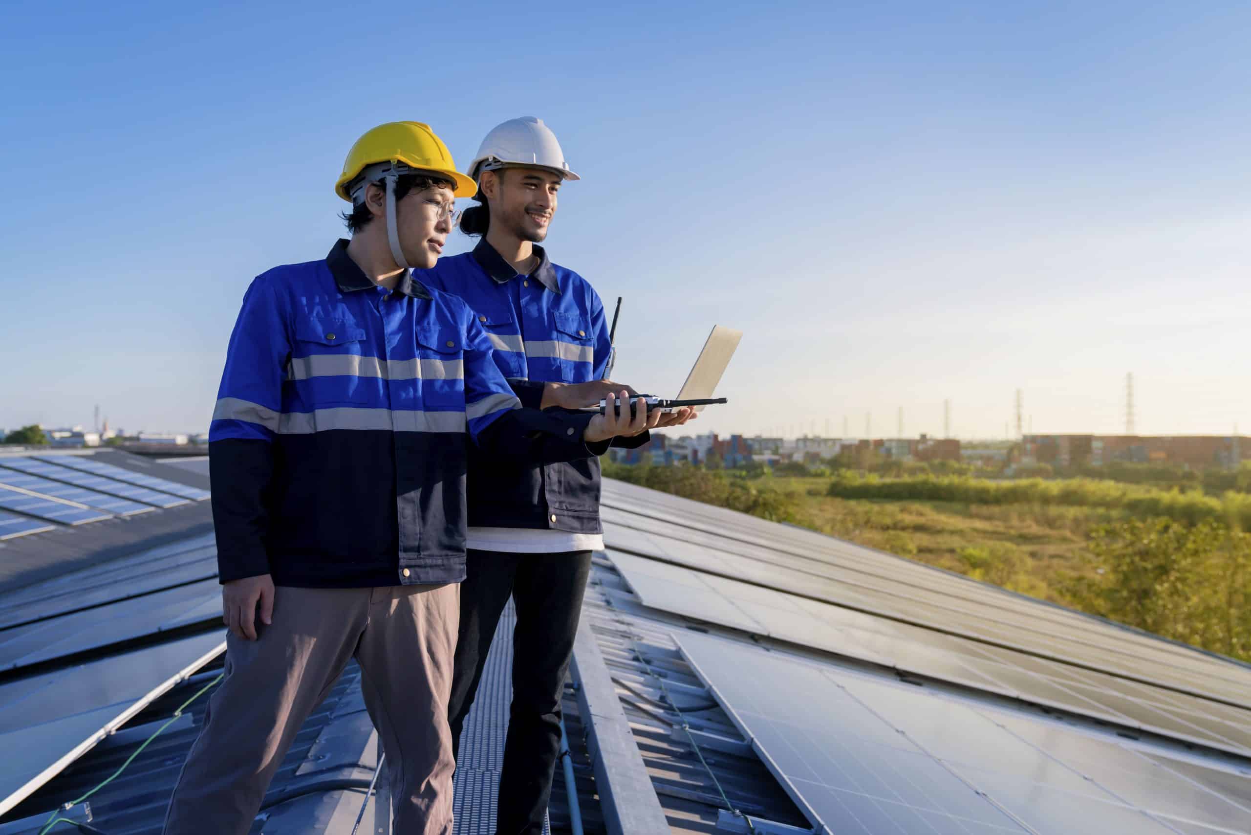 specialist technician professional engineer with laptop tablet maintenance checking installing solar roof panel factory rooftop sunlight engineers team survey check solar panel roof (1)