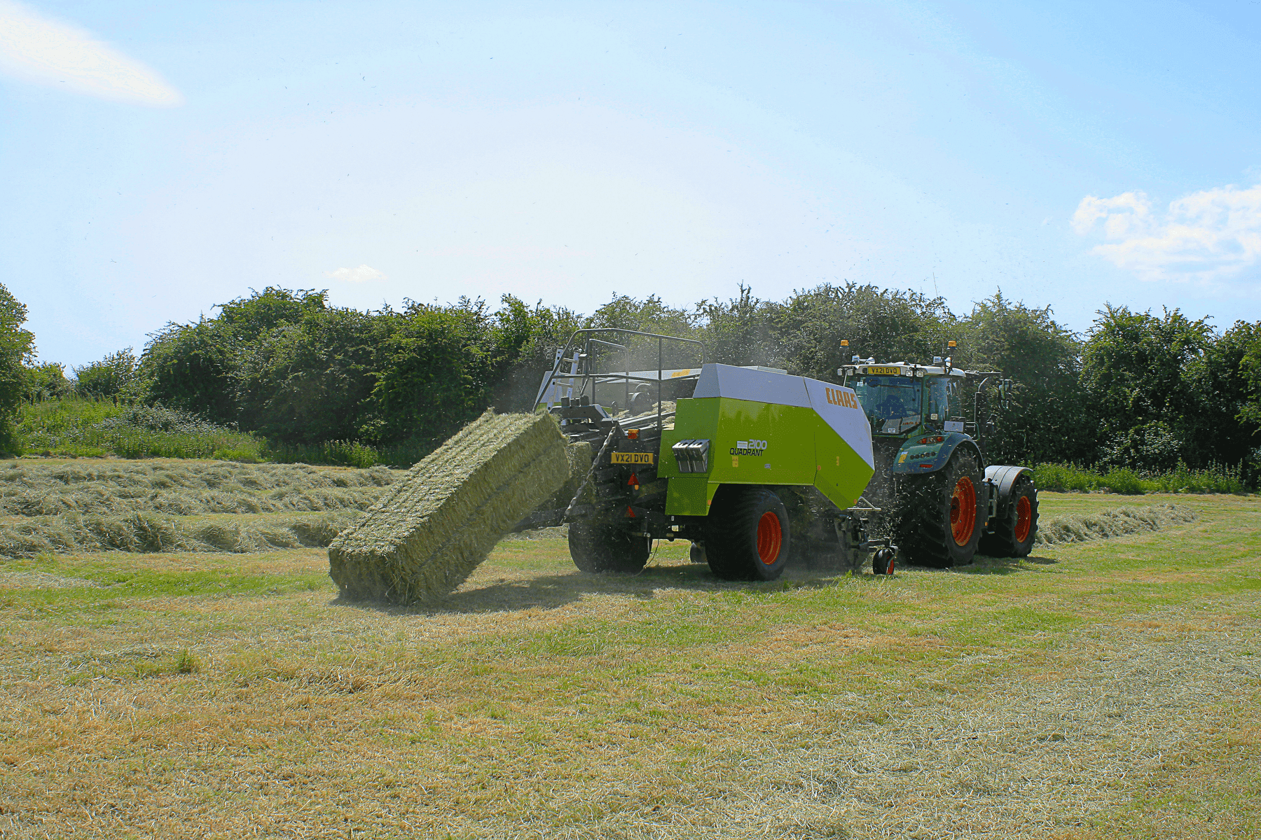 Tractor baling hay in a field
