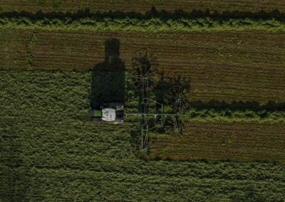 Aerial view of tractor in green field