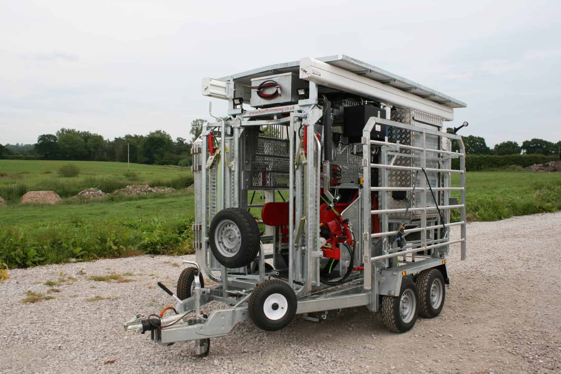 Mobile livestock hoof trimming trailer on a farm