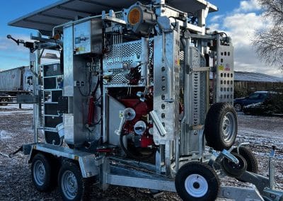 Mobile industrial equipment on snowy ground under clear sky.