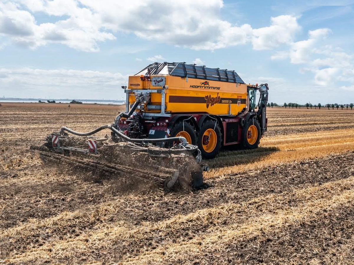Vredo with cultivator Modern farm machinery working in vast field