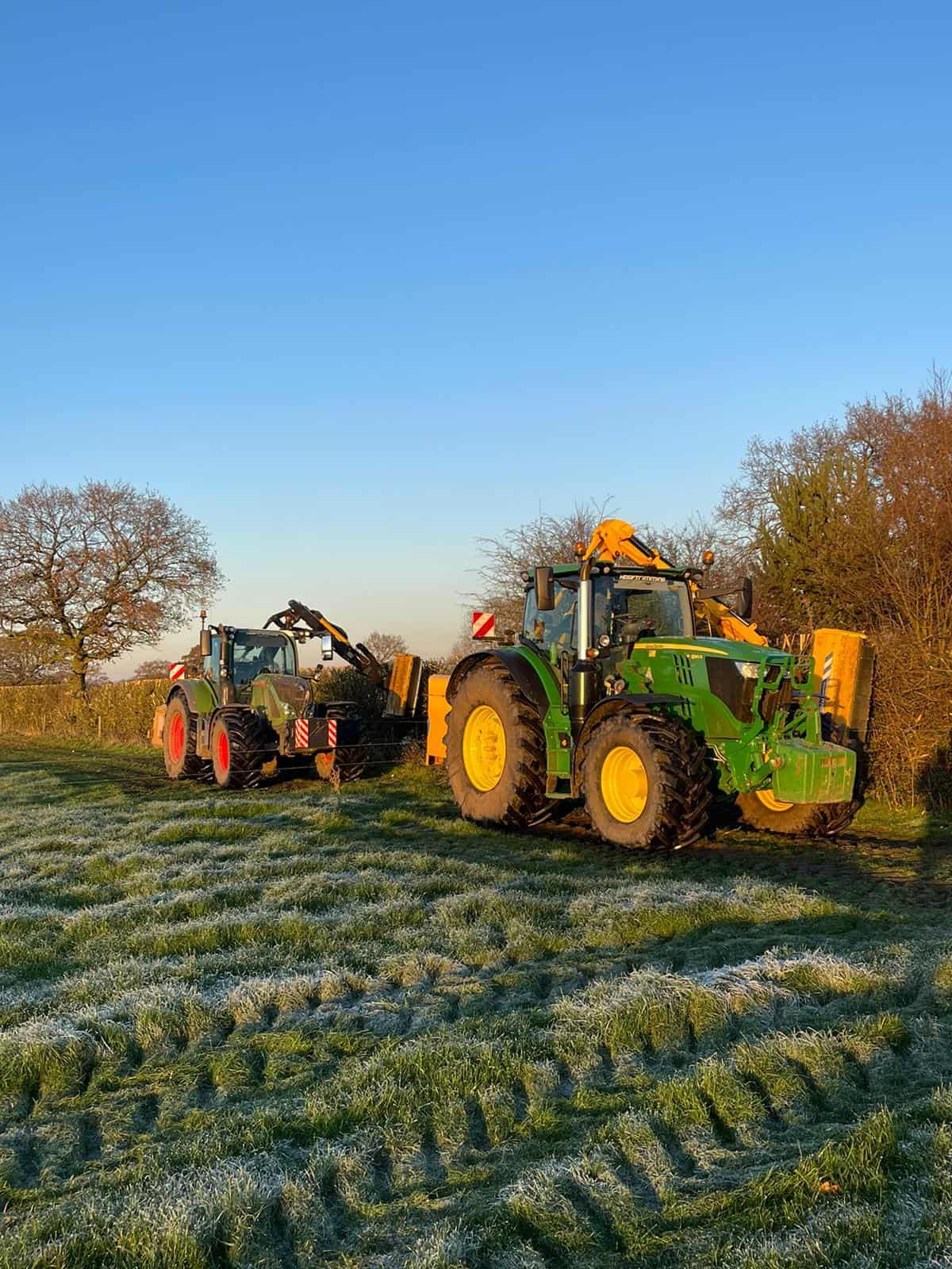 WFSG1316 Two tractors working in a frosty field at sunrise.