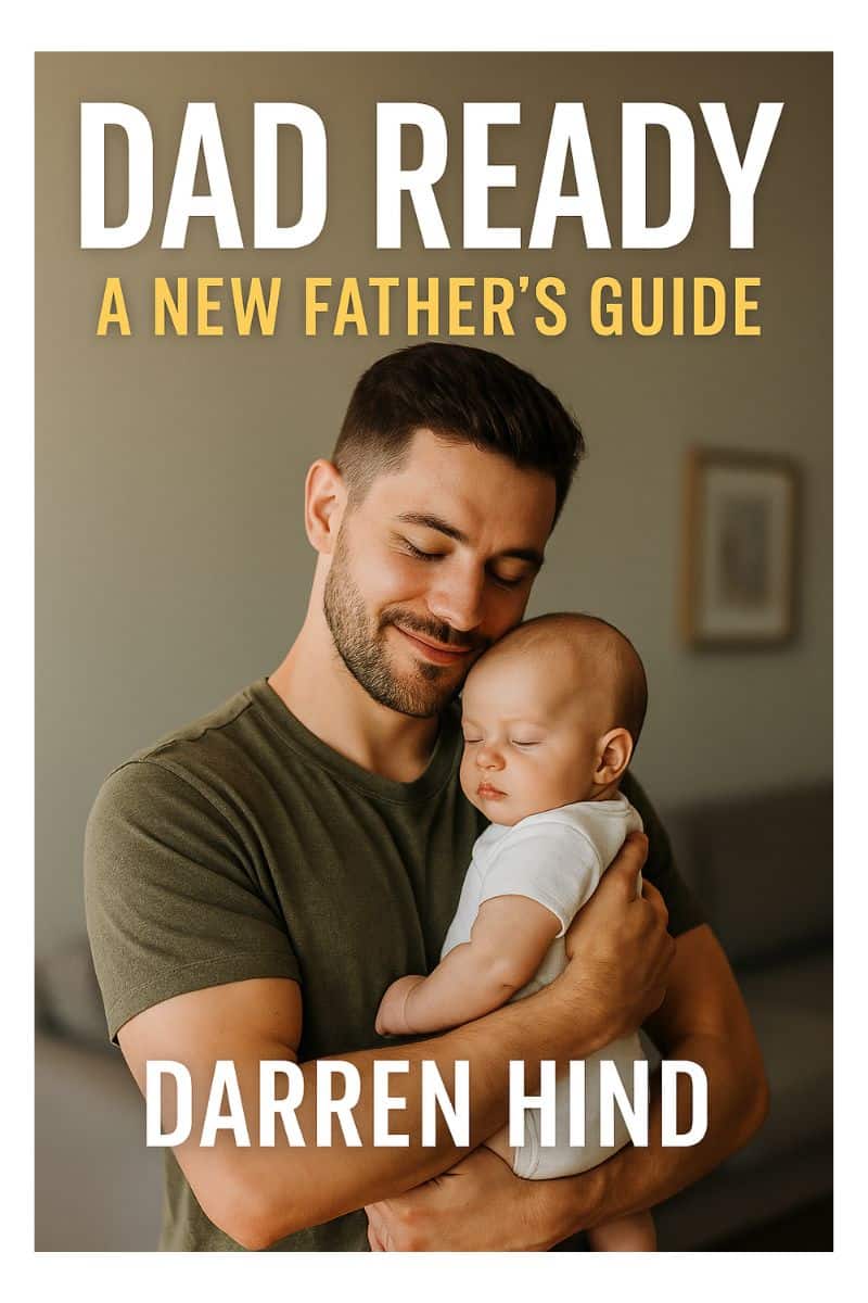 “Front cover of Dad Ready: The Ultimate New Dad Guide for Real-Life Fatherhood by Darren Hind, showing a smiling young father holding his baby with soft lighting and warm family tones.”