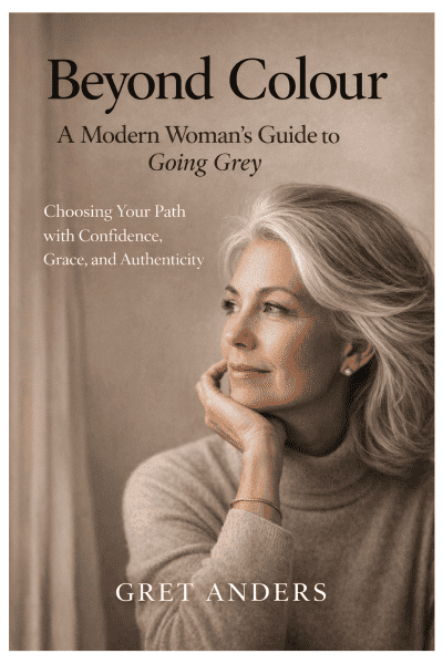 Front cover of the ebook “Beyond Colour: A Modern Woman’s Guide to Going Grey” by Gret Anders, featuring a confident grey-haired woman in soft natural light.