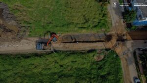 Maquinaria de construcción trabajando en proyecto urbano en Pitalito, Huila, Colombia, con calles en reparación y movimiento de tierra para infraestructura vial y desarrollo local.