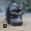 Front view of carved stone lion pyrogene showing mouth openings and striker base