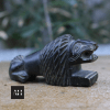 Overall view of antique carved stone lion smoking companion with functional design