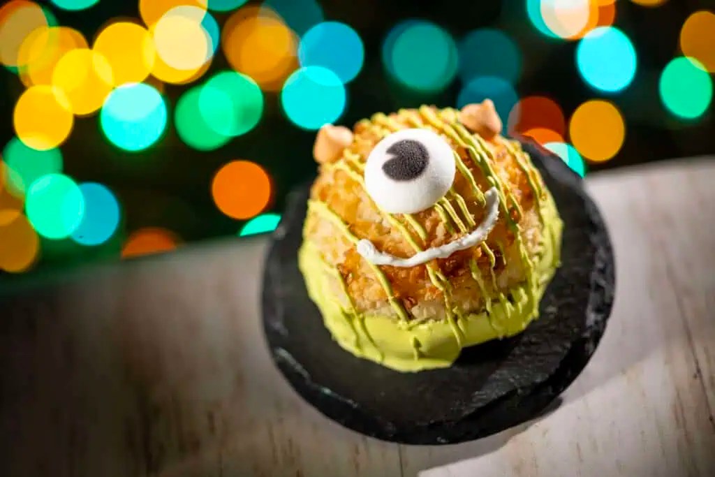 Brightly decorated sushi roll inspired by Halloween and Disney characters, featuring unique green and black accents.