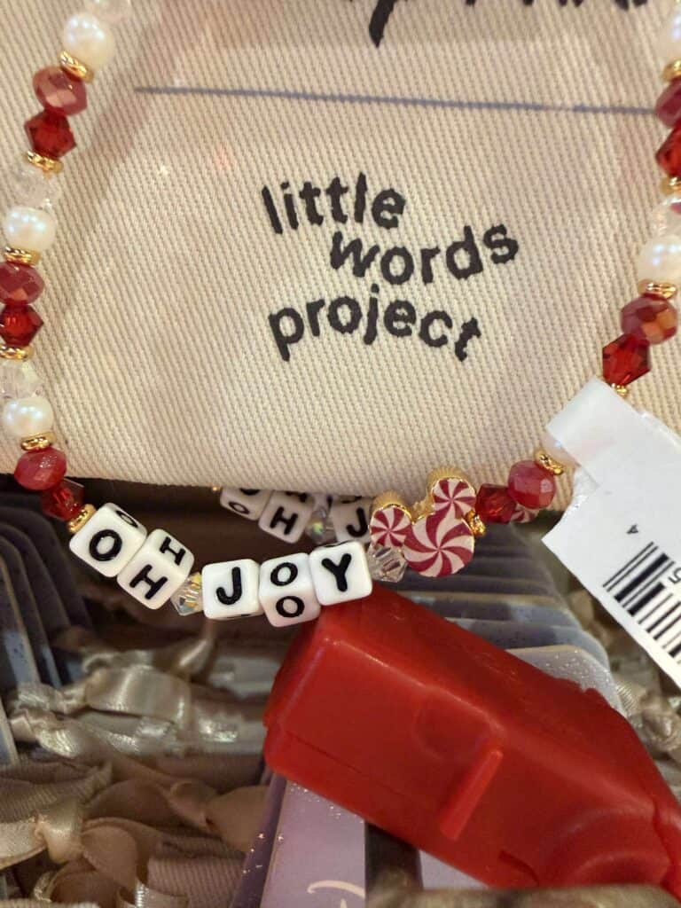 Festive beaded necklace with "joy" letters, peppermint candies, and holiday-themed charms, perfect for Christmas jewelry.