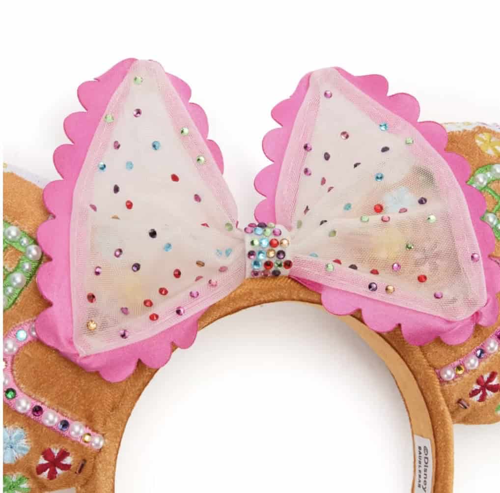 Colorful Disney Minnie Mouse ears headband with pink bow and decorative embellishments for Disney fans.