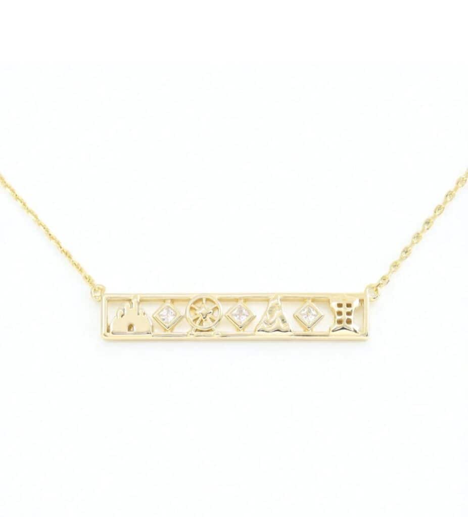 Gold frame necklace with Disney characters and sparkling gemstones, elegant and stylish jewelry piece.