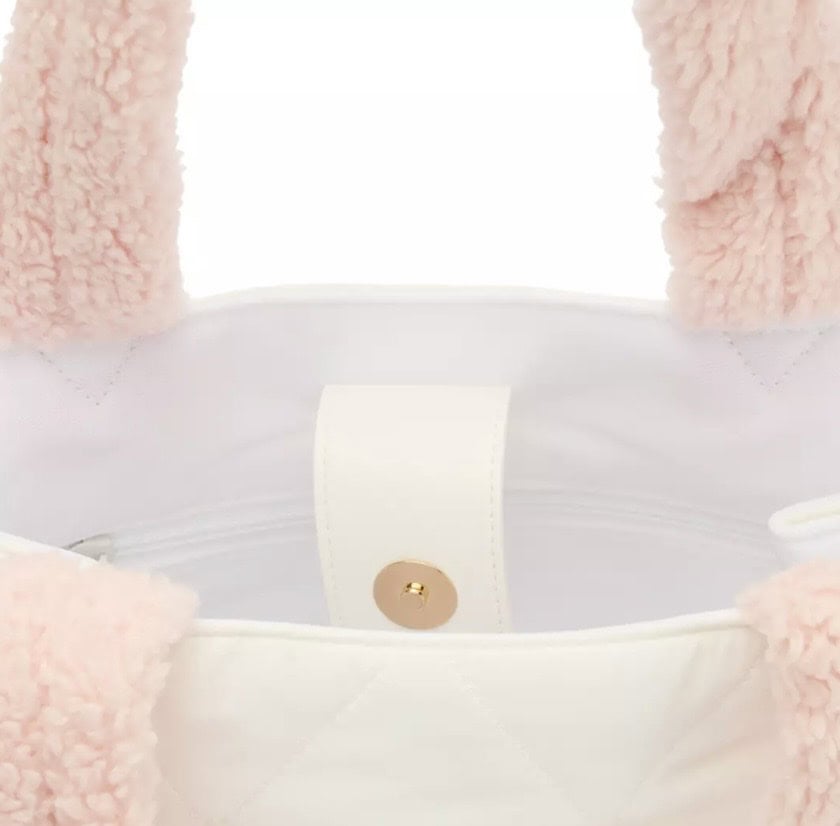 Soft pink fleece tote bag with white interior and gold snap closure, perfect for Disney fashion accessories.