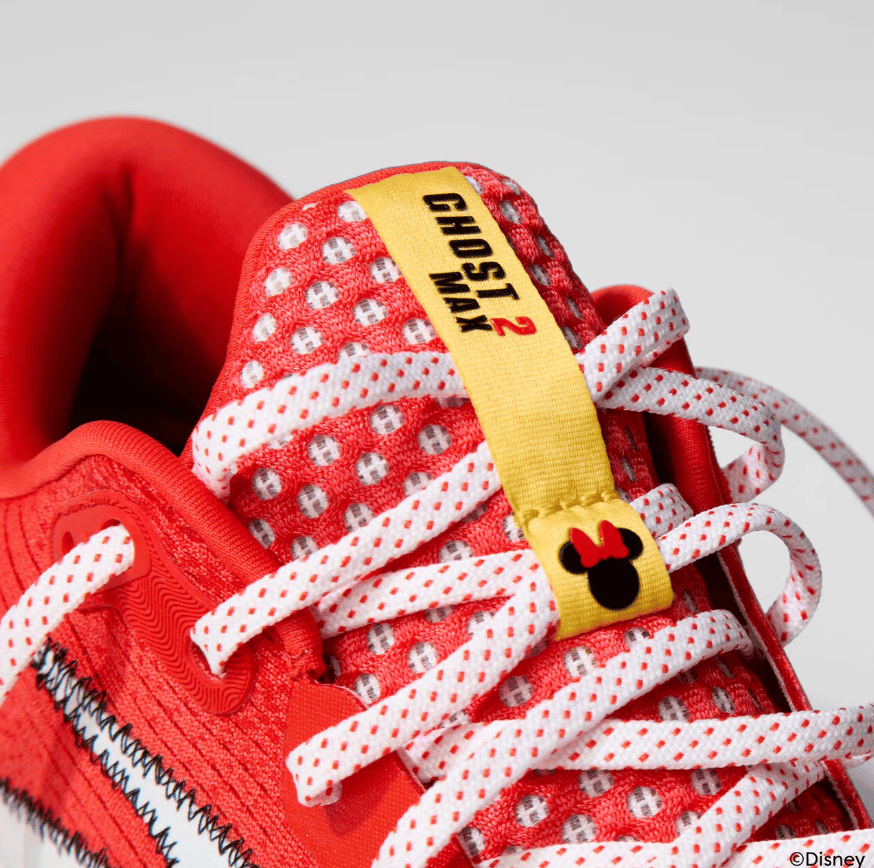 Red Disney running shoe with Minnie Mouse tag, sporty athletic footwear for women and kids.