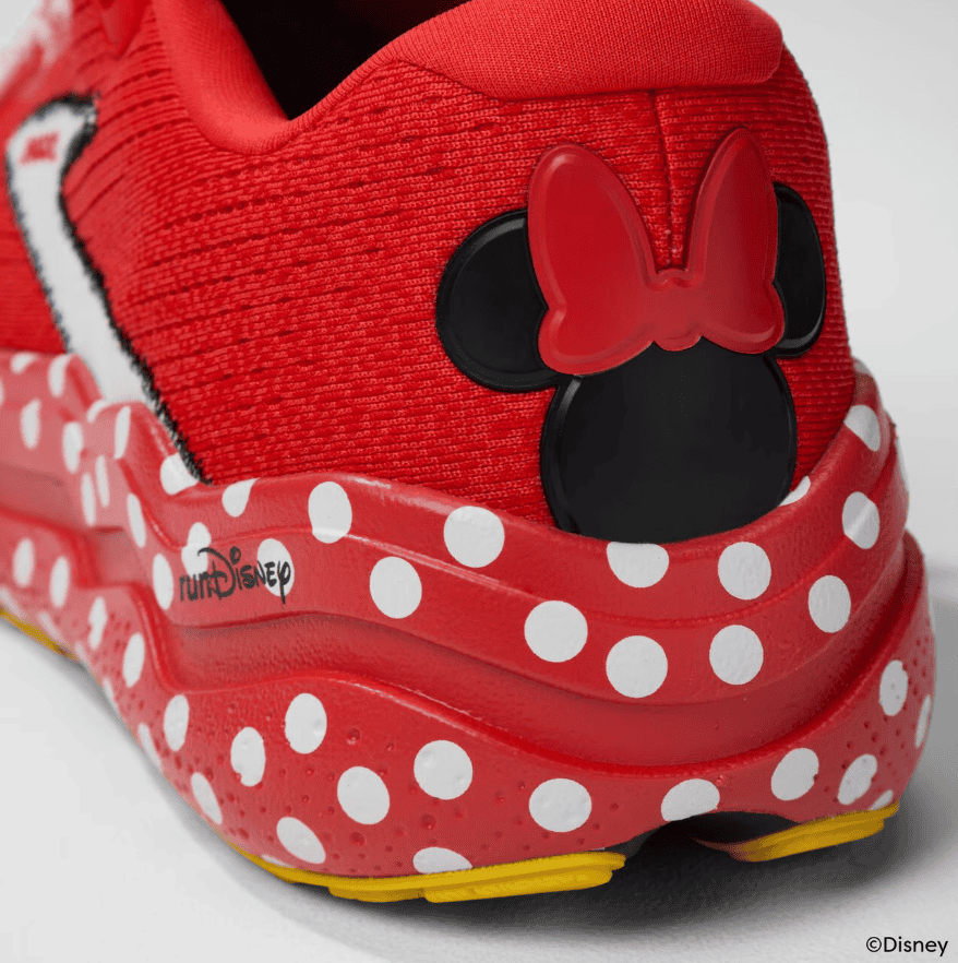 Red Minnie Mouse-themed Disney sneakers with polka dots and a bow detail.