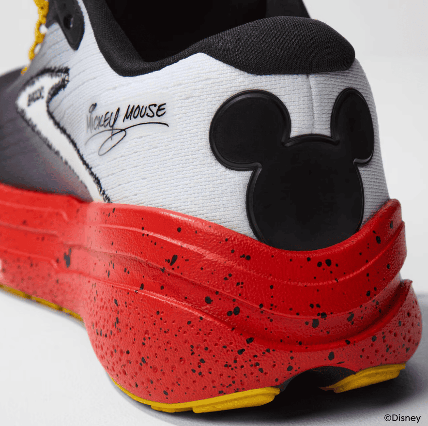 Mickey Mouse themed sneaker with iconic silhouette and vibrant red speckled sole.