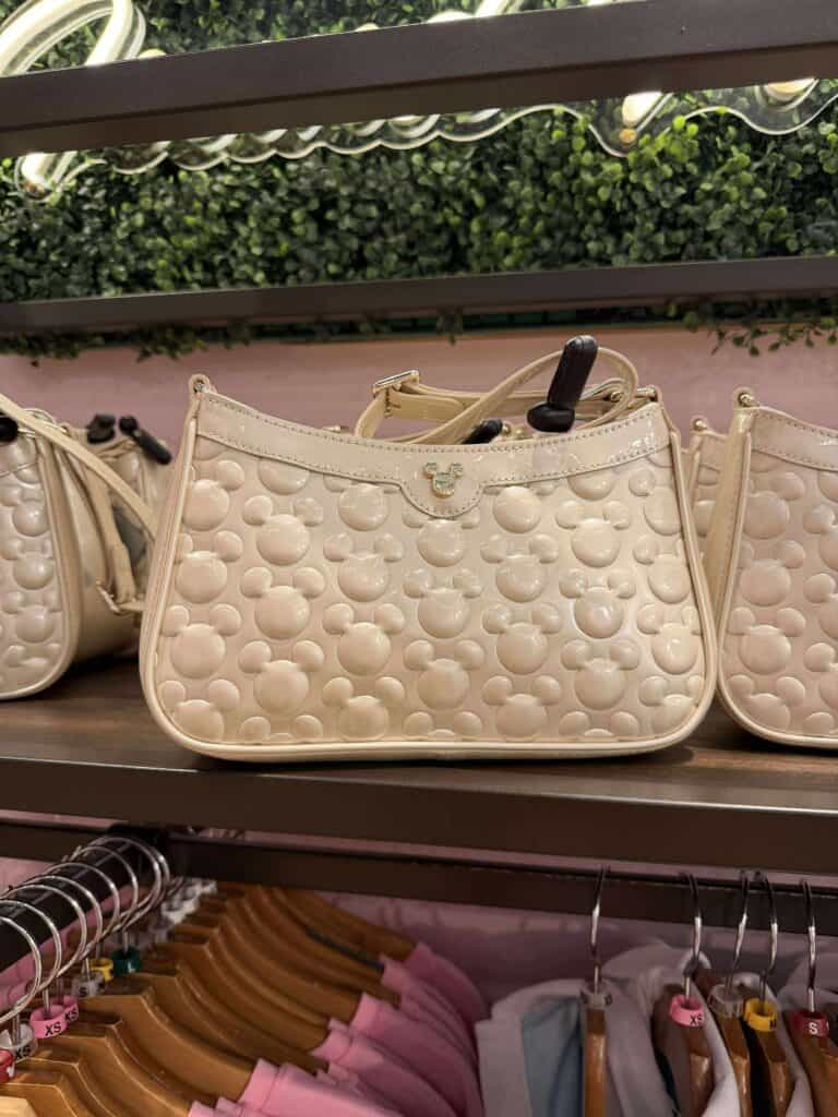 Cream-colored Disney-themed Mickey Mouse handbag with embossed pattern, perfect for Disney fashion lovers.