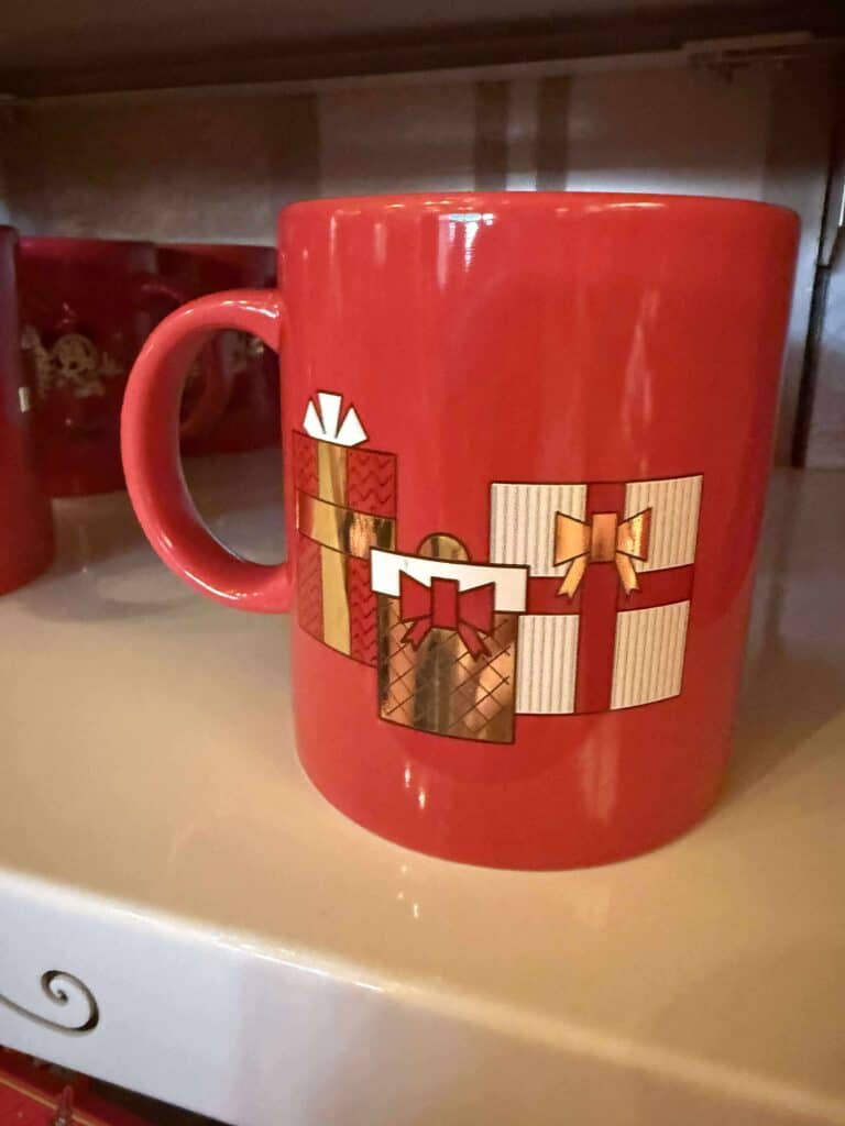 Red Christmas mug with presents design, Disney holiday-themed ceramic cup, festive Disney holiday mug.