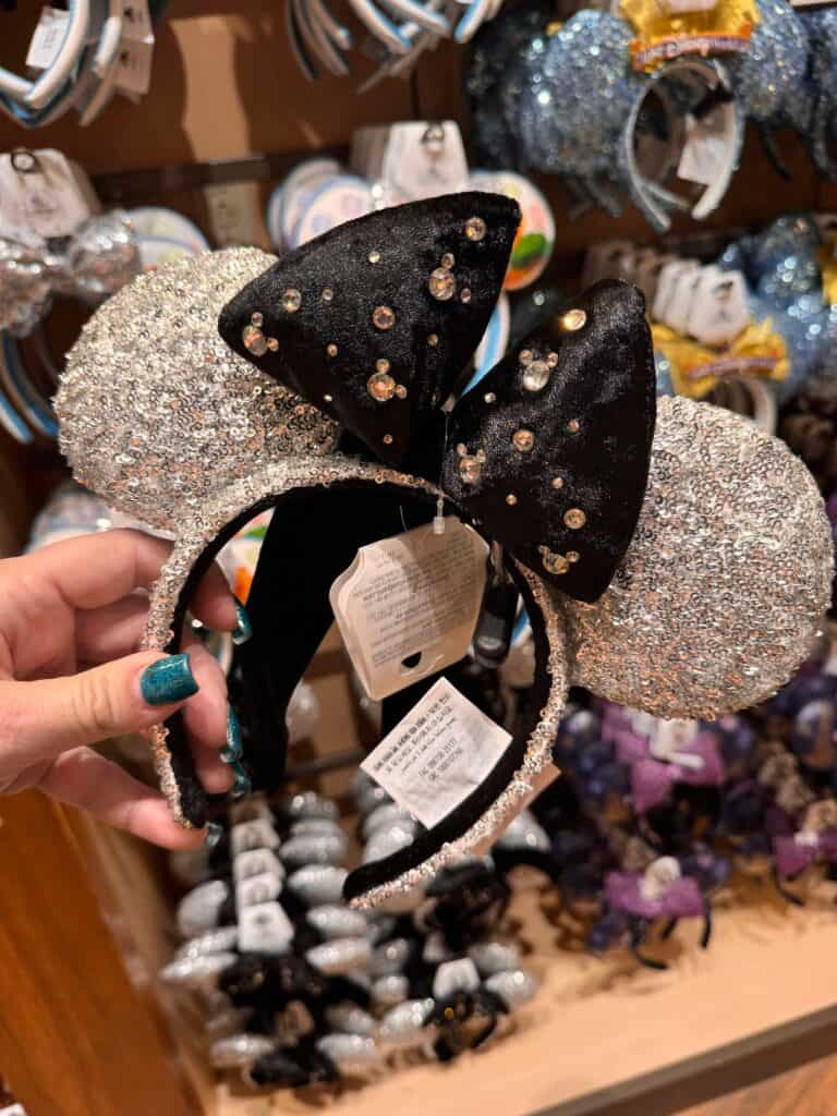 Glittery black and silver Disney Minnie Mouse ears headband with bow, sequined accessory for Disney fans and cosplay.