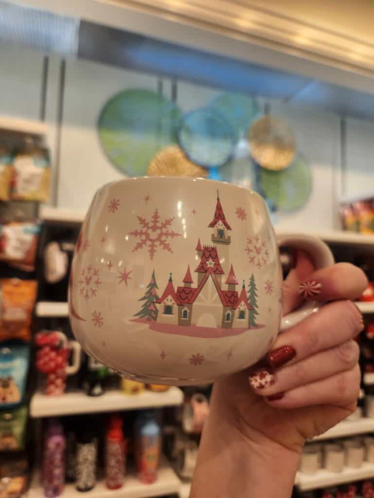 Decorative Disney-themed Christmas mug with castle and snowflake designs for Disney fans.