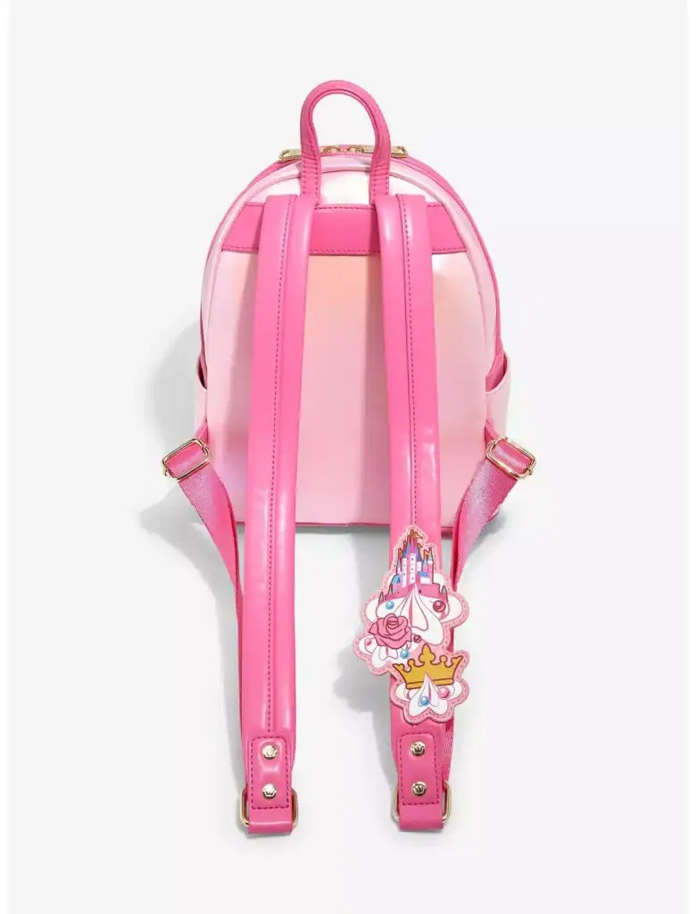 Pink Disney princess backpack with castle charm, perfect for Disney fashion enthusiasts.