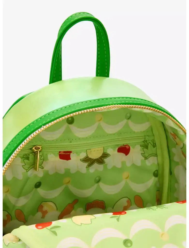 Bright green Disney-inspired backpack with floral and fruit pattern, gold zipper, and interior zipper pocket. Perfect for Disney fans and fashion enthusiasts.