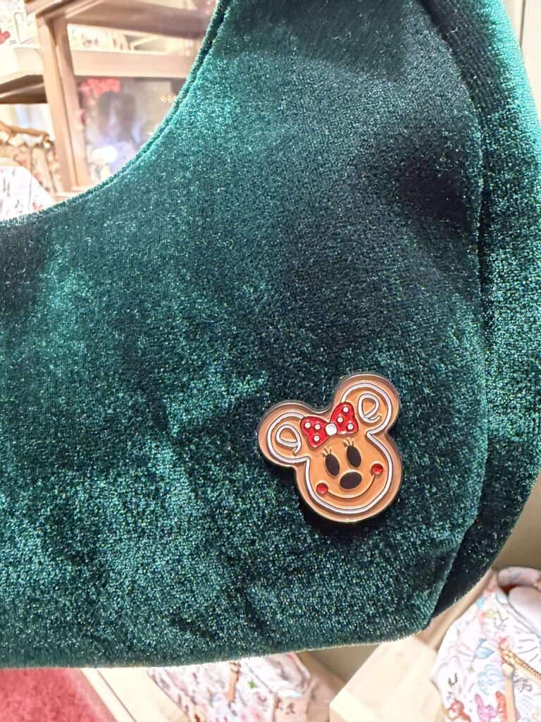 Vibrant teal glitter fabric with adorable Minnie Mouse pin accent.