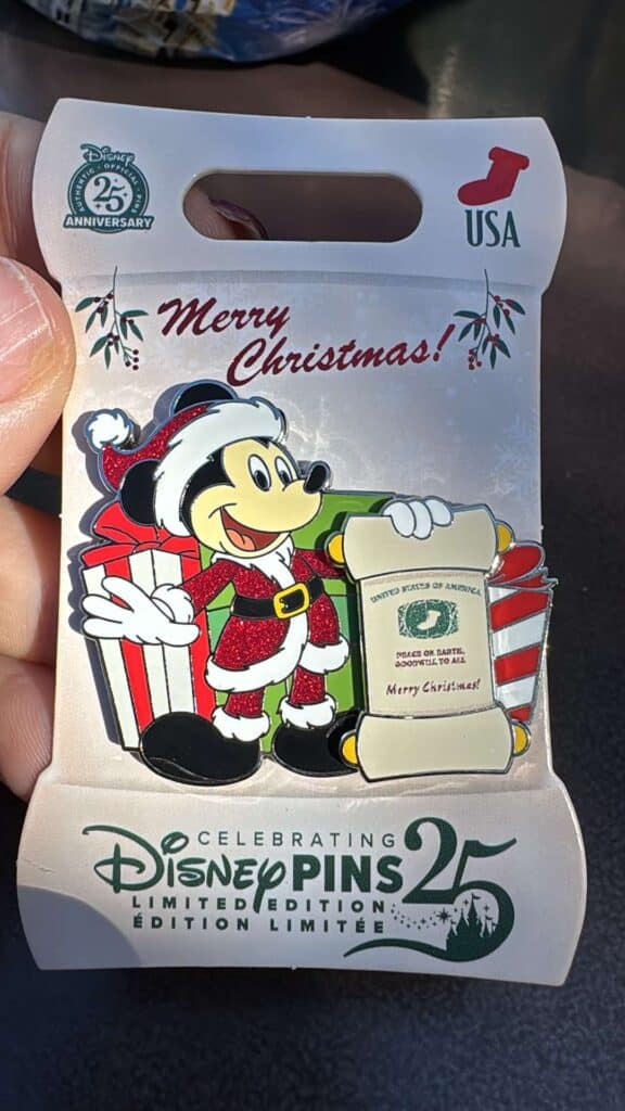 Colorful Disney Mickey Mouse Santa hat holiday pin, limited edition 25th anniversary collectible.