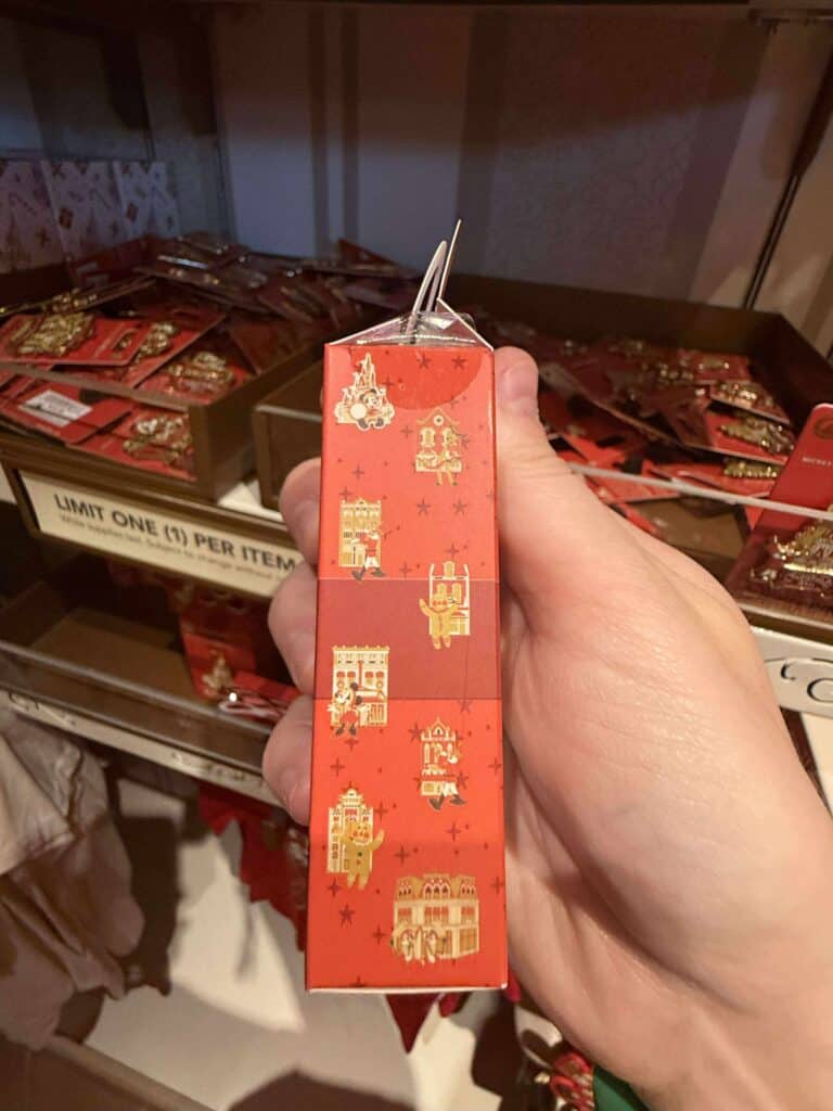 Christmas-themed Disney pin packaging with iconic Disney castle and character illustrations.