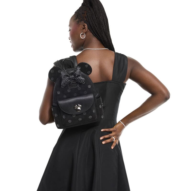 Minnie Mouse themed black backpack with bow and polka dot details for Disney fashion lovers.