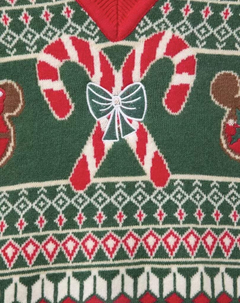 Festive holiday sweater featuring candy canes, bows, and Christmas patterns in red, green, and white.