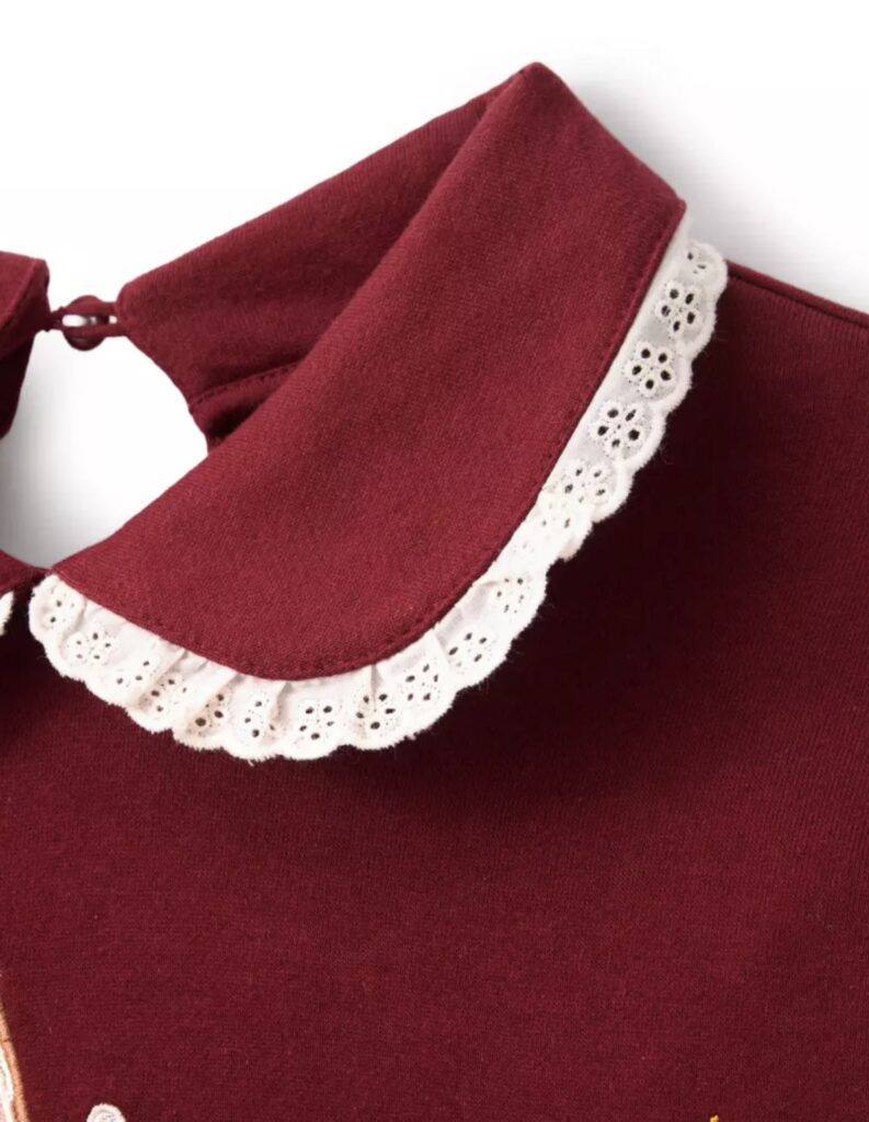 Elegant red Disney-inspired dress with white eyelet lace collar, perfect for Disney fashion enthusiasts and cosplay.