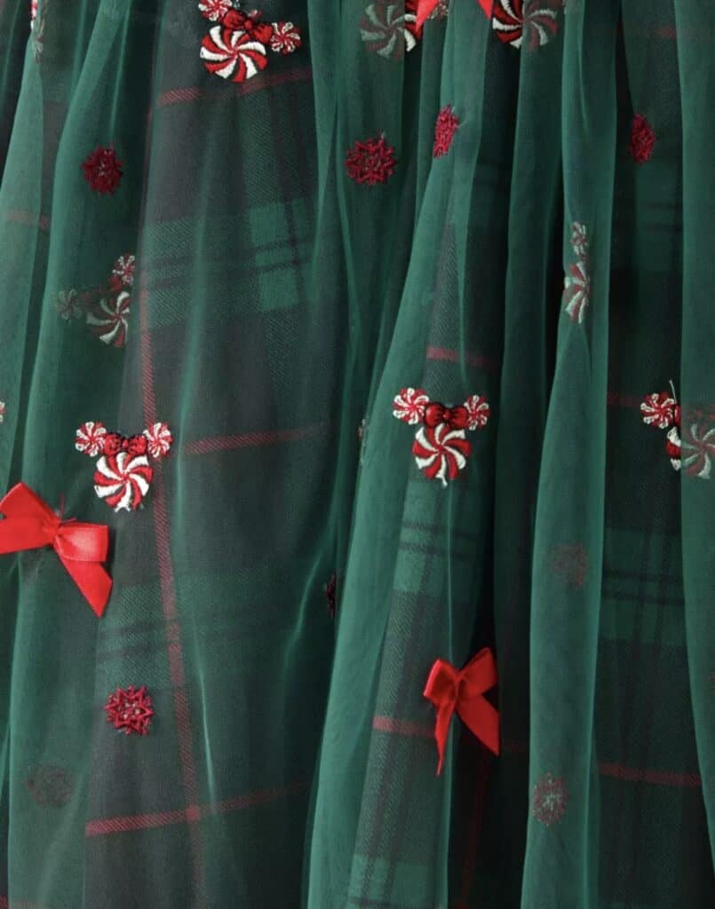 Candy cane embroidery on festive green tulle for Disney holiday fashion fans.