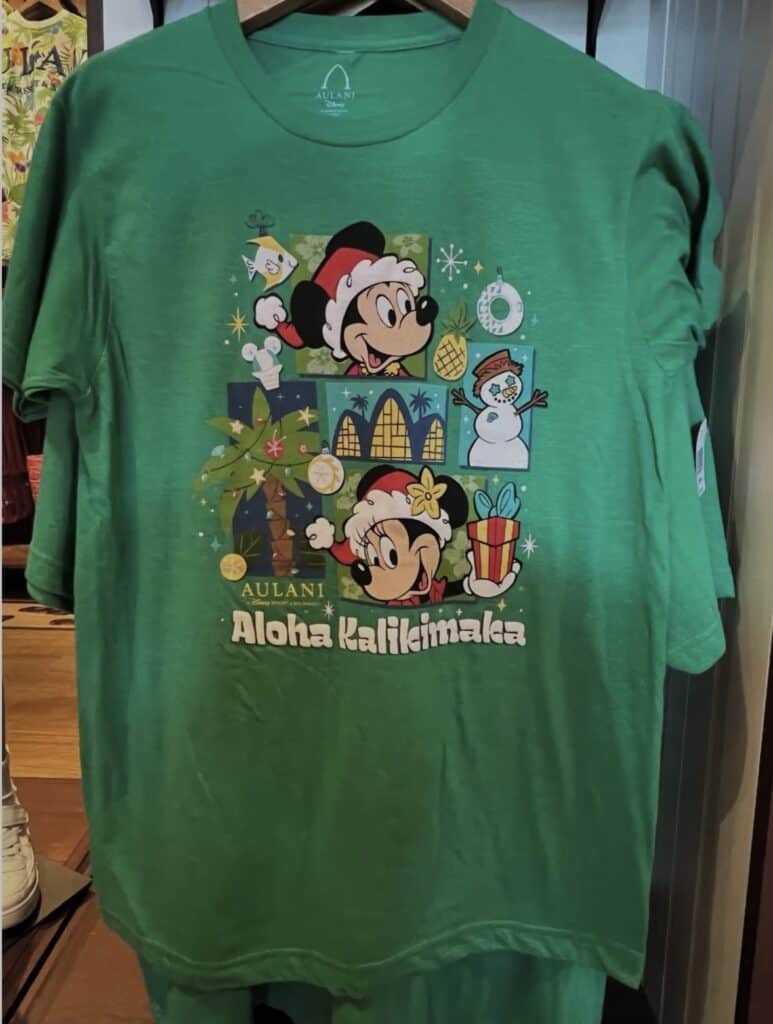 Bright green Disney Christmas T-shirt featuring Mickey and Minnie Mouse with holiday graphics, perfect for festive Disney fans.