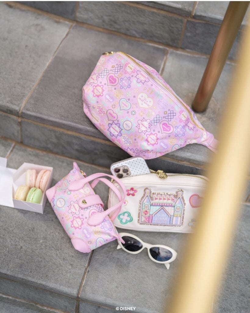 Pink Disney-themed cosmetic bag, accessories, and treats for Disney fans and fashionistas.
