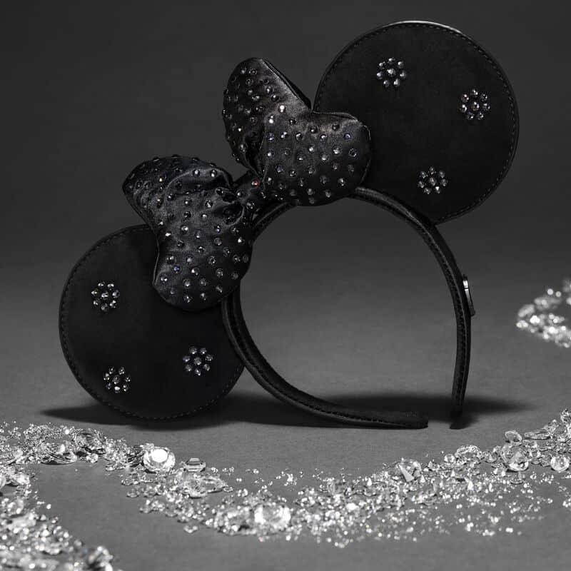 Black Minnie Mouse ears headband with rhinestone bow and glitter accents, perfect for Disney fashion lovers.