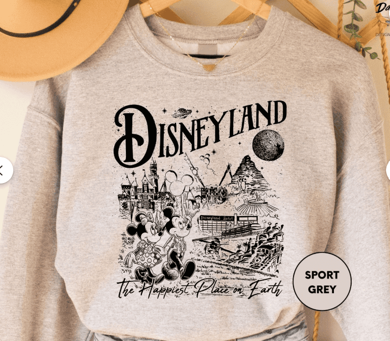 Disneyland themed grey sweatshirt featuring Mickey and Minnie Mouse with iconic park landmarks, perfect for Disney fashion fans.