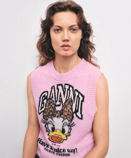 Soft pink Disney sweater with Daisy Duck graphic and leopard print bow, perfect for Disney fashion enthusiasts.