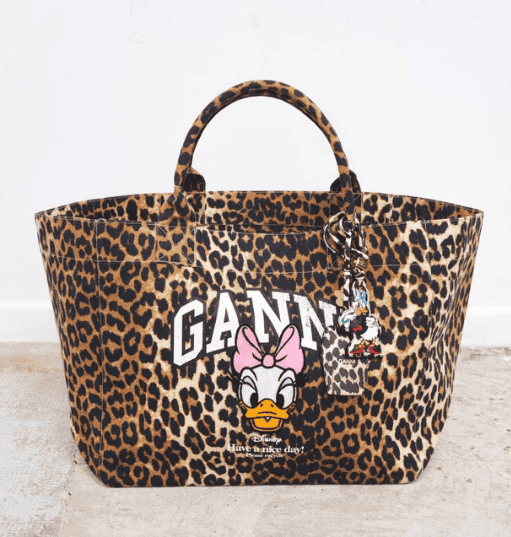 Leopard print Disney Ganny tote bag with Minnie Mouse and Donald Duck charms, perfect for stylish Disney fans.