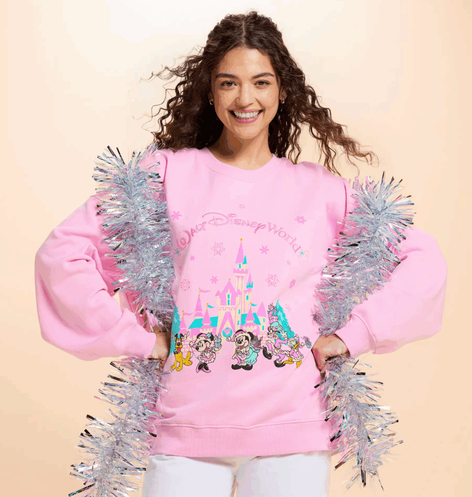 Bright pink Disney sweatshirt with classic Disney characters and castle graphic, fun for Disney fans.