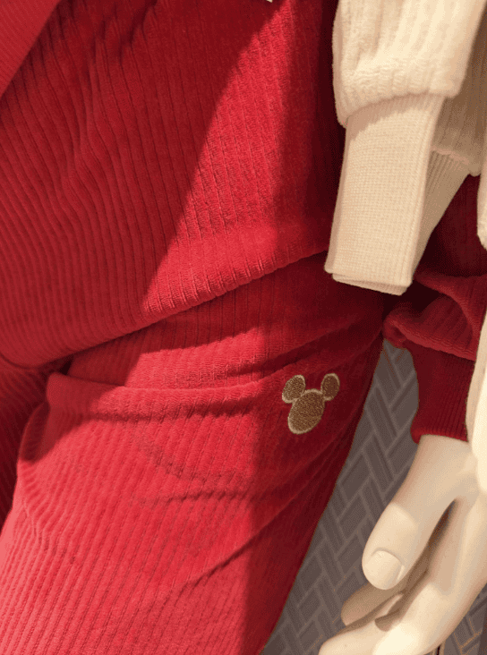 Disney Mickey Mouse-themed red cozy sweatshirt with gold embroidered logo for fans.