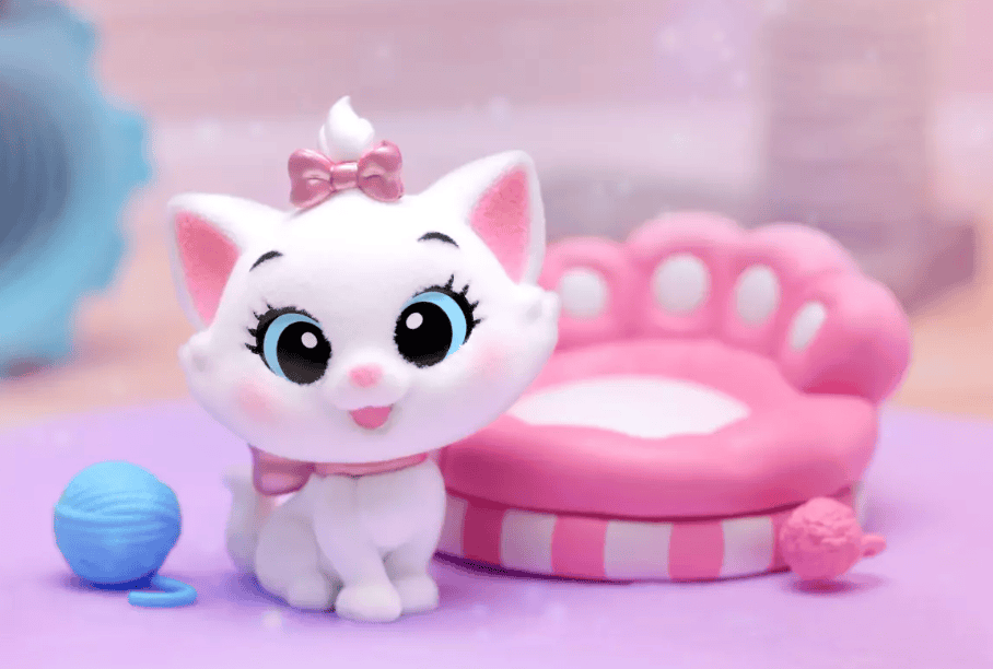 Adorable Disney kitten plush with pink bow, paw bed, and knitting ball, ideal for Disney-themed nursery or playroom.