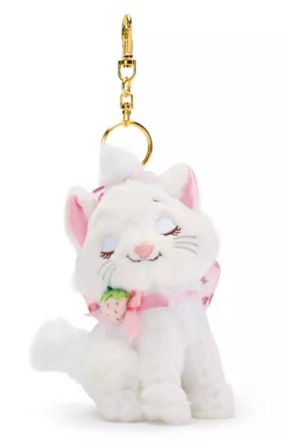 Fluffy white cat keychain plush with pink bow and strawberry accessory, Disney fashion-inspired accessory.